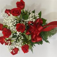 24-7 Love · One dozen red roses arranged in a clear glass vase with baby’s breath and greens.