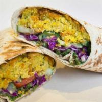 Falafelicious Wrap · Vegan. Falafel with a spread of hummus, cucumber-tomato salad, red cabbage slaw, tabouli & t...