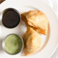 Vegetable Samosas · Crisp triangular patties stuffed with peas and potatoes cooked with spices and deep fried.
