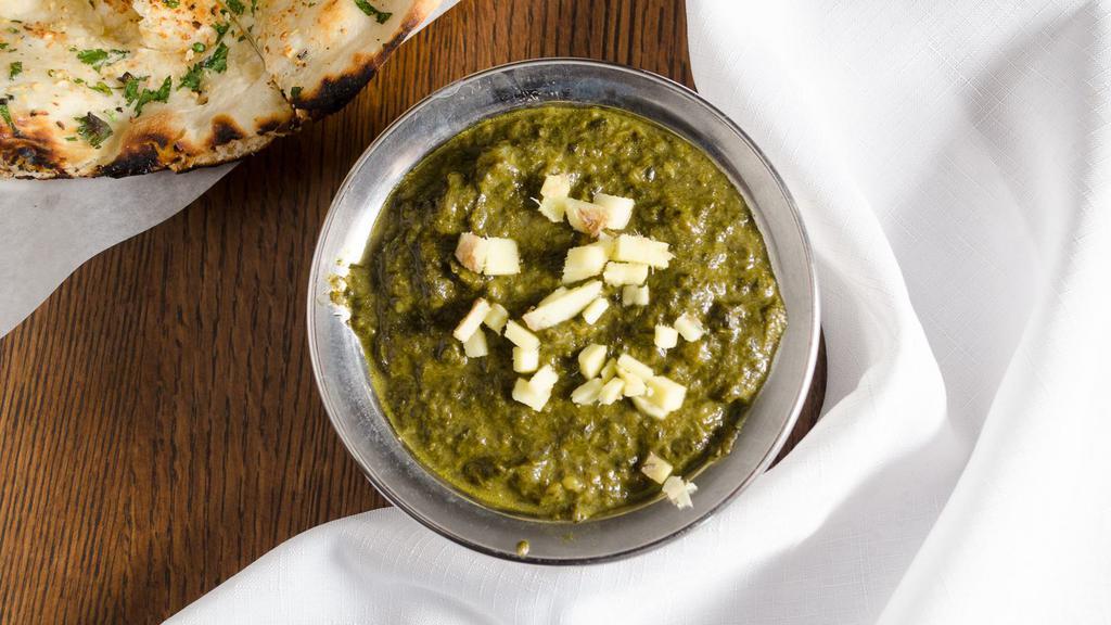 Palak Paneer · Spinach and homemade cheese in flavorful curry sauce.