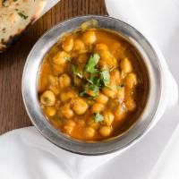 Chana Masala · Garbanzo Beans Cooked in Fresh Onions, Tomato and Flavorful Curry Sauce.