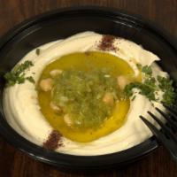 Spicy Hummus · Chickpeas, blended with tahini house spices, olive oil and Arabic hot sauce garnished with s...