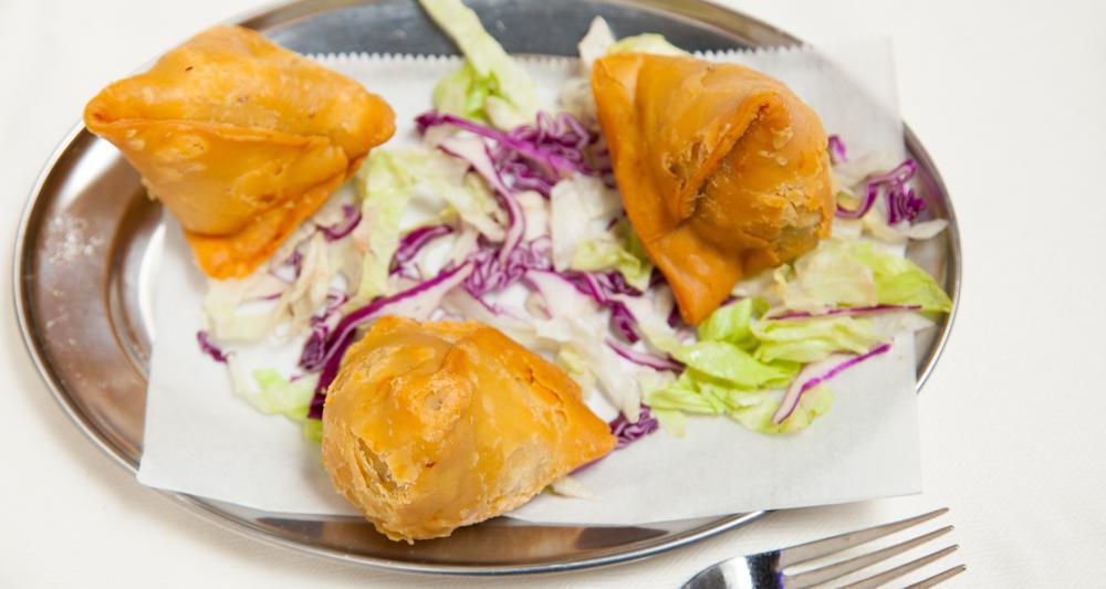 Samosa · Two pieces. Triangular pastries made of white flour stuffed with mildly spiced vegetables and fried.