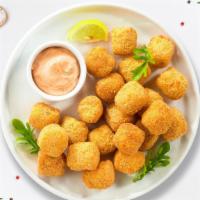 Top Of The Tot · (Vegetarian) Shredded Idaho potatoes formed into tots, battered, and fried until golden brow...