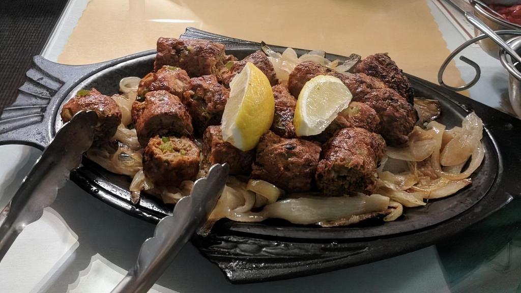 Seekh Kabab · Finely minced lamb seasoned with chopped onions, herbs and spices then baked on skewers in our tandoor oven.