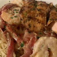 Scampi Angel Hair · Jumbo shrimp sauteed in garlic, capers, and roasted red pepper in a lemon white wine sauce s...
