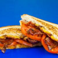 Adult Grilled Cheese · Four Wisconsin cheeses with tomato and bacon on toasted white bread.