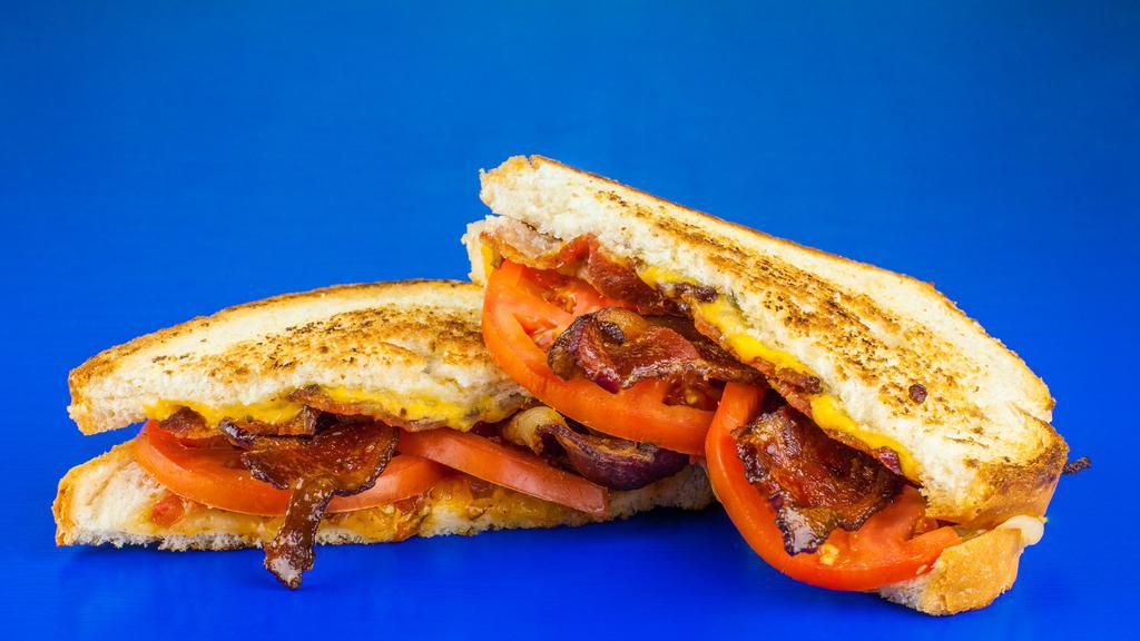 Adult Grilled Cheese · 4 Wisconsin cheeses with tomato and bacon on toasted white bread.
