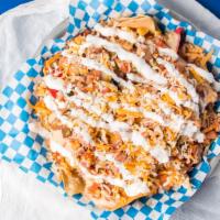 Deluxe Nachos · White queso with smoked southwest chicken and Cheddar blend served with fresh pico and sour ...
