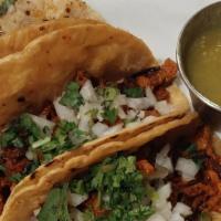 Tacos (3) Al Pastor · Marinated grilled pork topped with cilantro, onion, and lime. Served with choice of corn or ...