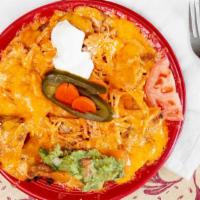 Nachos · Fresh tortilla chips with beans, melted cheese, guacamole, sour, jalapeños peppers, and toma...