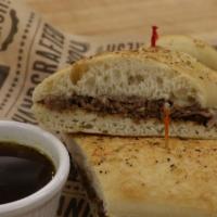 #13 French Dip · Slow Roasted Sliced Sirloin with Swiss Cheese on a French Baguette served with a side of Au ...