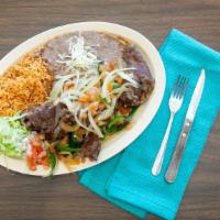 Bistec A La Mexicana · Steak topped with grilled onions, tomatoes, and pepper. Served with rice and beans.