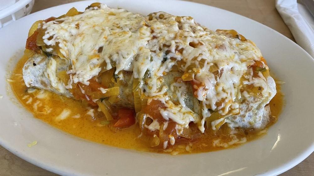 Suizo · Burrito with melted cheese and ranchero sauce on top.