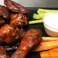 Smoked Chicken Wings · 12 House-brined chicken wings, smoked slowly with applewood and hickory. Flash-fried to cris...