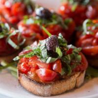 Bruschetta · Old world bread rubbed with garlic and topped with fresh chopped tomatoes, olive oil, spices...