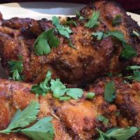Tandoori Chicken · Chicken, marinated in yogurt and authentic Indian spices and slowly cooked to perfection in ...