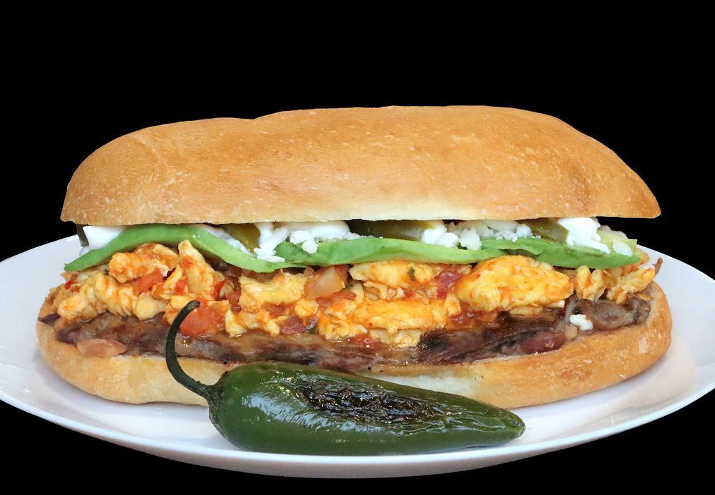 Torta La Mexicana · Steak, Two Scramble Eggs Cooked With Spicy Red Salsa, Mexican Queso Fresco, Avocado, Jalapeños, ChipotleMayo, Lettuce And Tomatoes. One Bag of Potato Chips on the Side