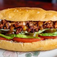 Torta Al Pastor · Marinated Pork, Cooked with Pineapple, Refried Beans, Cheese, Avocado, Jalapeños, lettuce, t...