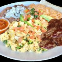 Huevos A La Mexicana Y Carne · Scramble Eggs with Fresh Jalapeños, Tomatoes & Onions. Served with Rice and Refried Beans. T...