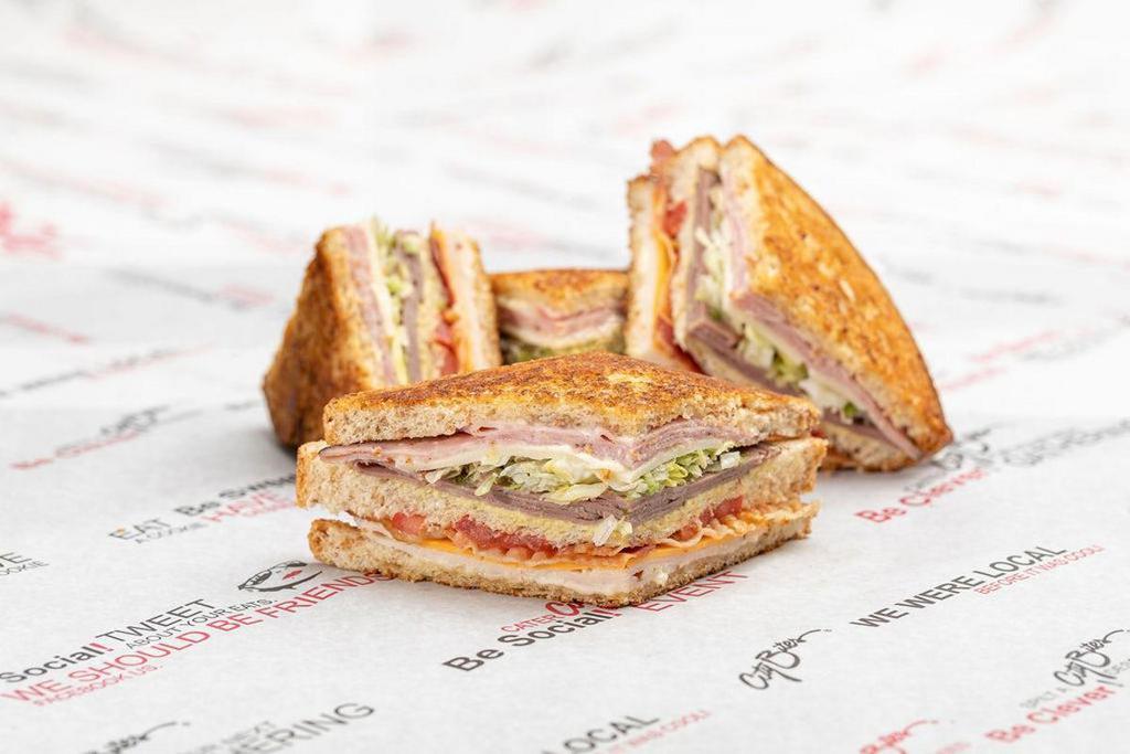Triple-Decker Club · Turkey, ham, roast beef, bacon, marble jack, provolone, lettuce, tomatoes, mayo & honey mustard, layered on three slices of our grilled wheat berry bread