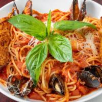 Seafood Pasta · Beer mussels, calamari and shrimp sauteed in our tomato basil sauce. Served over linguine.