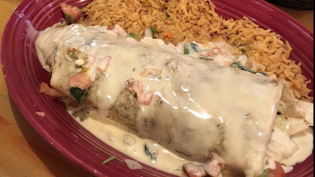 Burrito Carne Asada · A burrito filled with carne asada, onions, peppers, and beans. Then smothered with cheese and salsa verde. Served with rice and pico de gallo.
