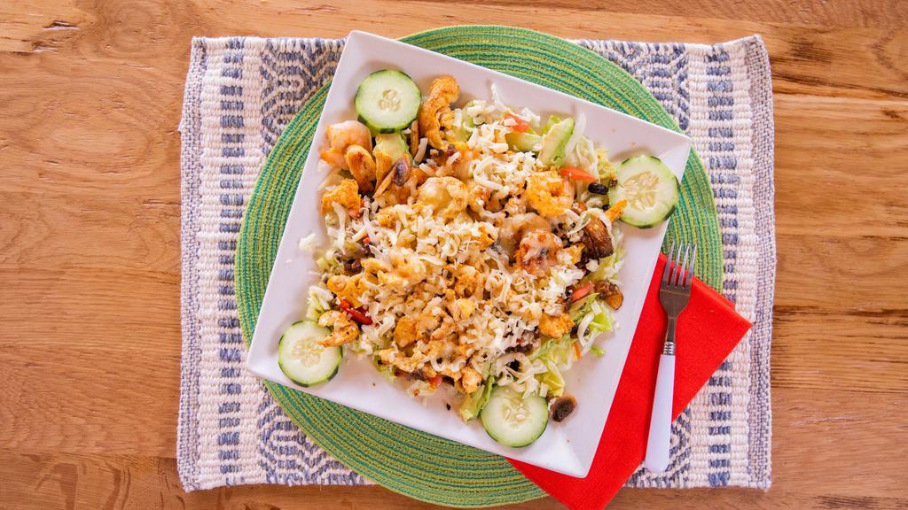 El Rodeo Salad · Grilled chicken and shrimp served over a bed of mixed greens with whole black beans, cucumbers, tomatoes, cheddar cheese, and avocado cubes. Topped with sautéed mushrooms. Served with your choice of dressing.