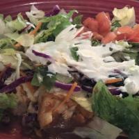 Supreme Enchilada · Four enchiladas, one each of chicken, beef, bean, and cheese, topped with lettuce, sour crea...