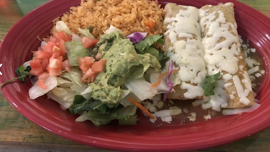 Verdes Enchilada · Three chicken enchiladas topped with green tomatillo sauce and melted cheese. Served with lettuce, rice, and sour cream.