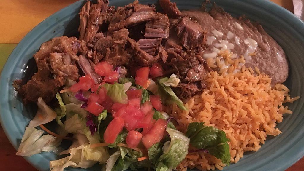 Carnitas Dinner · Our tender roast pork is served with rice, beans, pico de gallo, crema salad, and three soft warm flour tortillas.