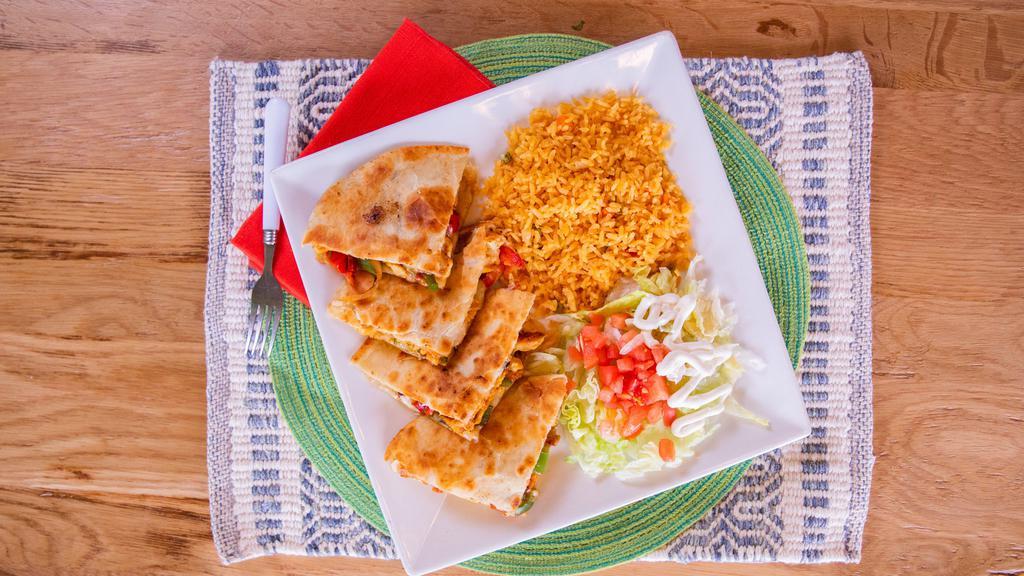 Super Fajita Quesadilla · The super taste of a fajita in a quesadilla. A jumbo flour tortilla stuffed with your choice of grilled chicken, juicy steak, or pork with tomatoes, onions, peppers and melted cheese. Served with rice and guacamole salad.