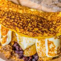Pabellon Cachapa · Cachapa filled with black beans, shredded beef, plantains, white cheese and butter