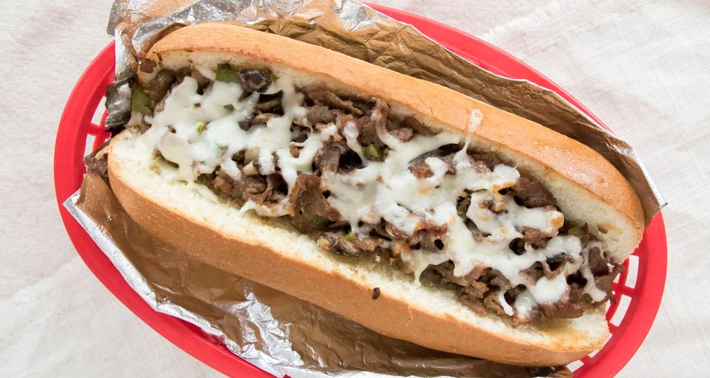 Philly Cheesesteak · Toppings include sauteed onions and mushrooms, lettuce, tomatoes, banana peppers, and mayonnaise. Comes with American cheese, and Swiss cheese.