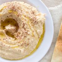 Hummus · Chickpeas based dipping, served with a pita bread.