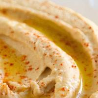 Hummus · chickpeas, sesame saucee, lemon juice and garlic. Drizzled with extra virgin olive oil and s...