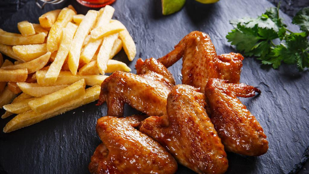 Hot Wings With Fries · Delicious chicken wings baked, then deep-fried to perfection and tossed in High-heat hot sauce. Served with a side of Fries.