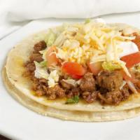 Taco (Corn Tortilla) · A Soft Corn Tortilla Topped with your Choice of Meat, lettuce, tomato, sour cream and Cheese.