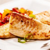 The Tilapia · Exquisite tilapia slowly cooked with charmoula, vegetables and fresh lemons.