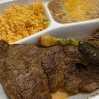 Carne Asada / Grilled Meat · Steak served with guacamole, sour cream, pico de gallo, onions, jalapeño toreado (flame-gril...