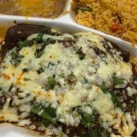 Mole Enchiladas · Three enchiladas filled with Mexican chicken mole. Topped with onions and queso fresco.