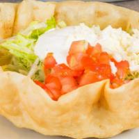Taco Salad · A flour tortilla bowl. Filled with beans, lettuce, tomatoes, cheese, sour cream, and guacamo...