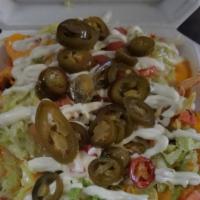 Nacho Supreme · Botanas. Served with beans choice of meat. Lettuce, tomatoes, sour cream and jalapeños.