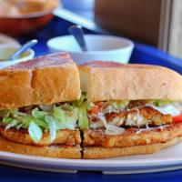 Torta De Milanesa / Breaded Chicken Torta · Our tortas are come on a torta bread with refried beans, mayonnaise, guacamole, onions, toma...