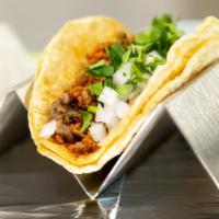 Taco Campechano · Unique in the taco world for combining chorizo and steak, one taco on a corn tortilla with c...