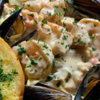 Seafood Alfredo · chicken, crawfish, shrimp, mussels 
Comes with garlic bread
