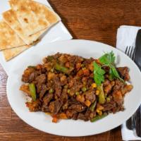 Beef Suqaar & Flatbread · Beef Suqaar: cubes of beef cooked with vegetables and spices;
Flatbread: soft pita bread;
(M...