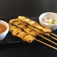 Satay Gai · Four Grilled marinated chicken on skewers served with peanut sauce and cucumber salad.