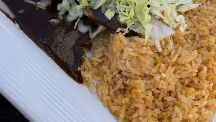 Enchiladas Poblanas · New! Three (3) enchiladas covered with pork and mole sauce. Served with crema salad and rice.