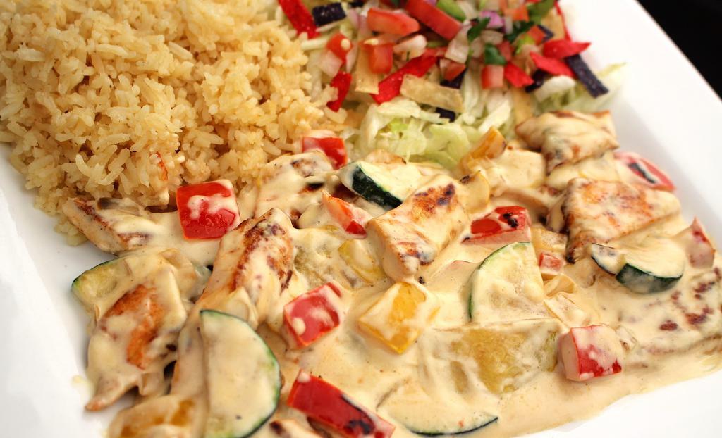 Pollo Con Crema & Chipotle · Grilled chicken with creamy chipotle sauce served with rice, beans and a side of tortillas.